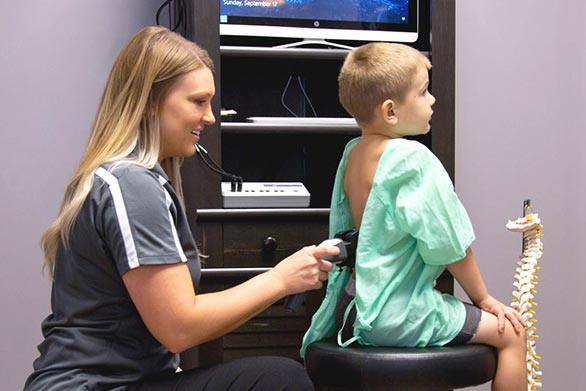 Chiropractic Traverse City MI Sheena Konas Examining Child Patient Chiropractic Traverse City MI Sheena Konas Examining Child Patient