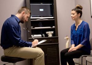 Chiropractor Traverse City MI Dr. Kyle Konas With Patient Chiropractor Traverse City MI Dr. Kyle Konas With Patient