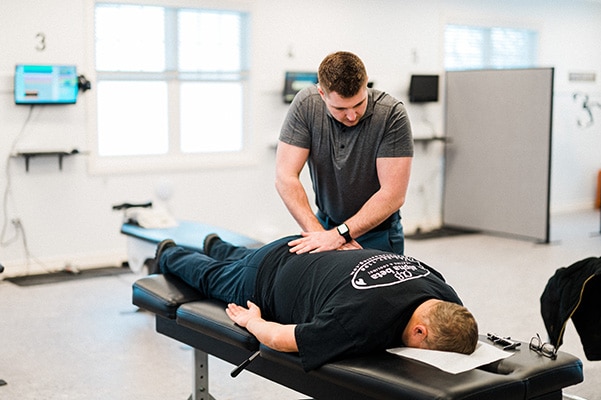 Chiropractor Traverse City MI Kyle Konas Adjusting Patient